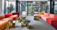 Kindred office lobby area with sofas and tables, view into the building