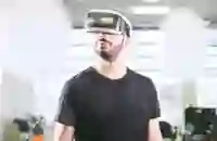A person wearing VR-goggles looking happy